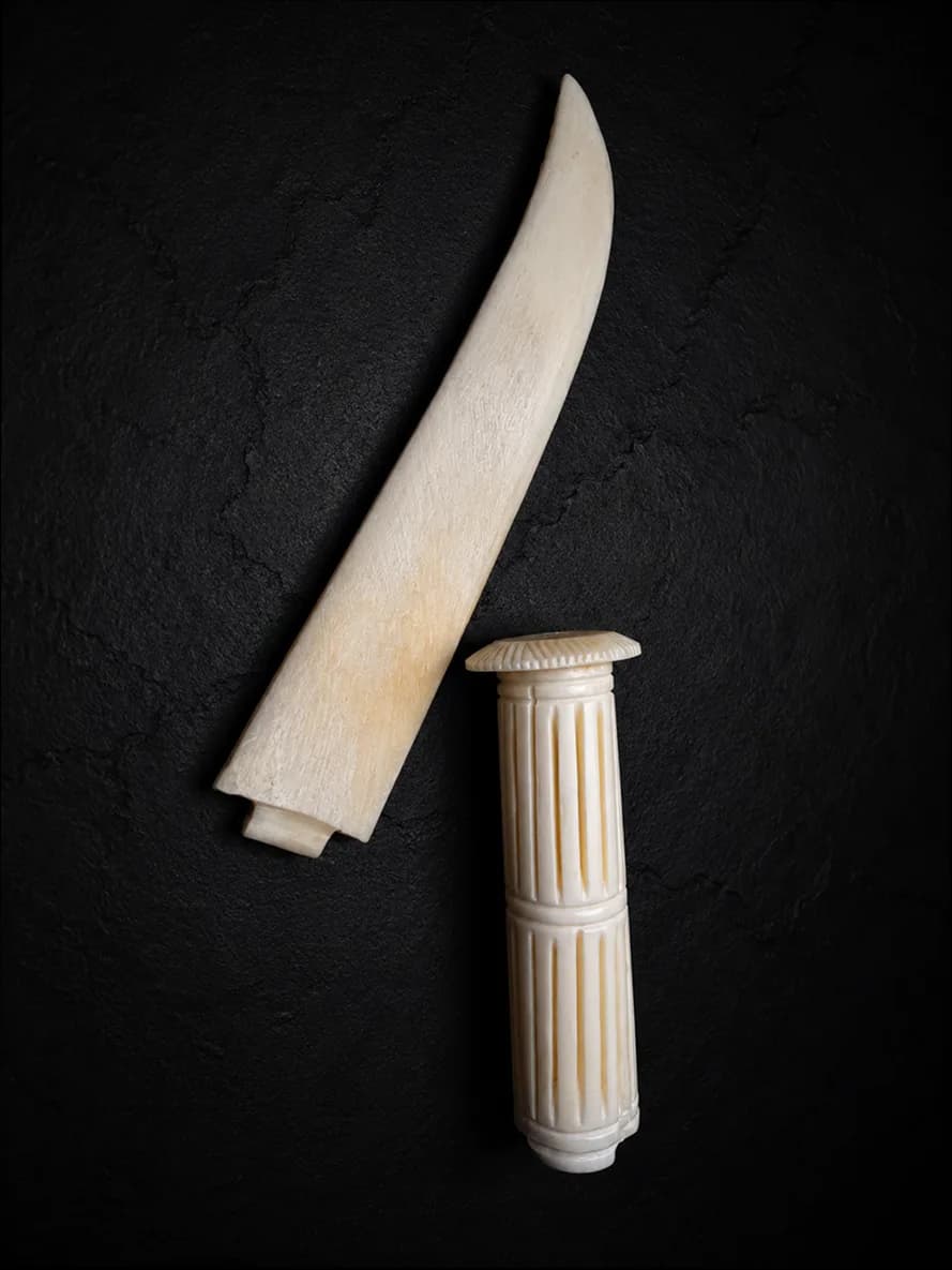 Carved buffalo-bone piece photographed on dark stone (4 of 10)