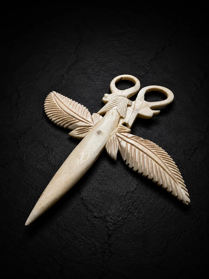 Carved buffalo-bone piece photographed on dark stone (6 of 10)