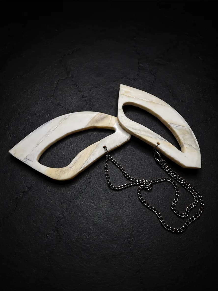 Carved buffalo-bone piece photographed on dark stone (9 of 10)
